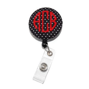 May include: Black and white polka dot fabric badge reel with a red monogram "ACB" in a circle.