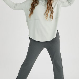 oman wearing Tencel oversized turtleneck in sage, Canadian made women's loungewear, front