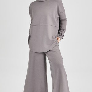 oman wearing Tencel oversized turtleneck in black, Canadian made women's loungewear, front