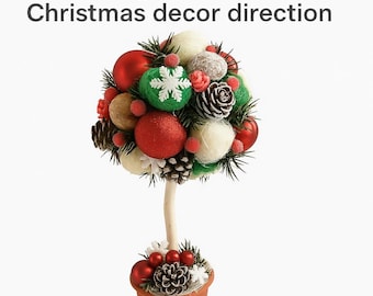 May include: A decorative Christmas tree made of red, green, and white ornaments, pinecones, and faux greenery. The tree sits in a small brown pot and has a wooden trunk. The text "Digital PDF Christmas decor direction" is at the top.