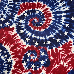 May include: A patriotic tie-dye fabric design featuring a spiral pattern in red, white, and blue. White stars are scattered across the fabric. The design evokes a sense of Americana and celebration.