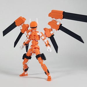 May include: An orange and white articulated action figure featuring a mechanical design with large, wing-like structures extending from the back. The wings consist of orange segments connected to long, flat, black blade-like components.