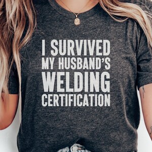 I Survived My Husband&#39;s Welding Certification T-Shirts, Funny Wife Shirts, Welding Life, Proud Wife Shirts, Sarcastic T-Shirts