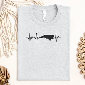 North Carolina heartbeat t-shirt, state pride shirt, North Carolina state outline tee, heartbeat graphic top, NC love shirt