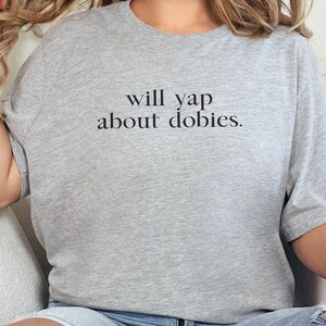 May include: A gray t-shirt with the text "will yap about dobbies." printed on the front.
