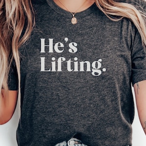 Hes Lifting T-Shirts, Funny Gym Tee, Workout Shirts, Weightlifting Gift, Fitness Apparel, Motivational Shirts, Gym Humor, Gift for Trainer