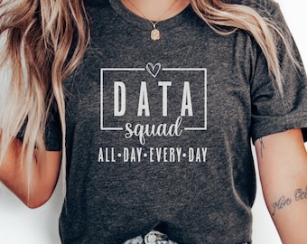 May include: Dark gray t-shirt with the text "DATA squad" inside a white rectangle, with a small heart above the word "squad". Below the rectangle is the text "ALL • DAY • EVERY • DAY".