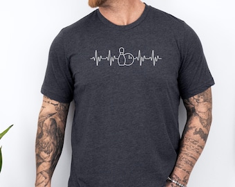 May include: A dark gray t-shirt with a white graphic of a bowling pin and ball with a heartbeat line above and below. The graphic reads "I love bowling".
