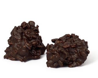 May include: Two dark chocolate clusters with a crunchy texture. The clusters are made with chocolate and a crispy cereal.