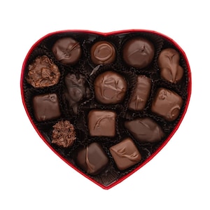 May include: A heart-shaped box of assorted chocolates with a red border. The chocolates are various shapes and sizes, with a dark brown color. The box is filled with individual chocolate pieces, perfect for gifting or enjoying.