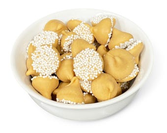 May include: A white bowl filled with milk chocolate kisses covered in white sprinkles.