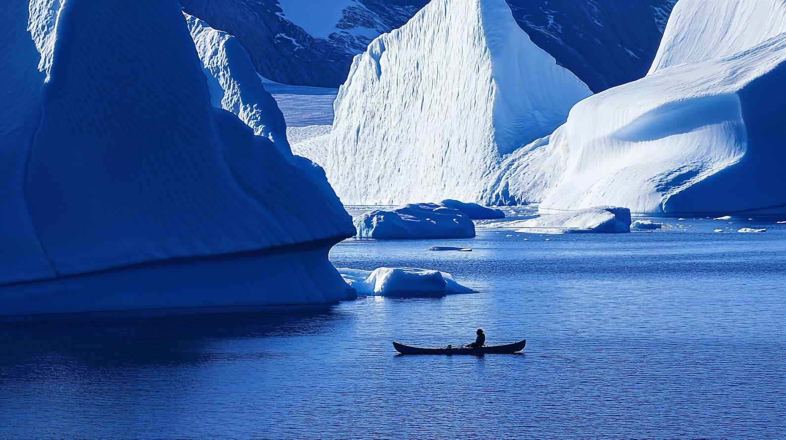 Kayaking Shadow Greenland Hunter Kayaking in the Shadow of Huge Icebergs in Aqua ...
