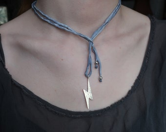 Sterling Silver Hammered Lightning Bolt Pendant on Light Blue Silk Cord.