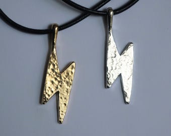Hammered Lightning Bolt Pendant hung on adjustable sliding knot black leather cord.