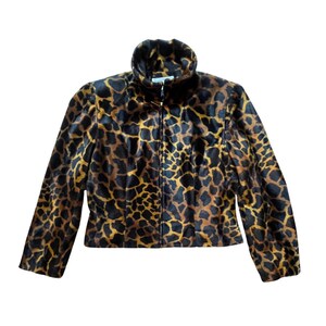 May include: A full-zip jacket with a giraffe print pattern in shades of brown and tan. The jacket has a high collar and long sleeves. The fabric appears to be soft and textured.