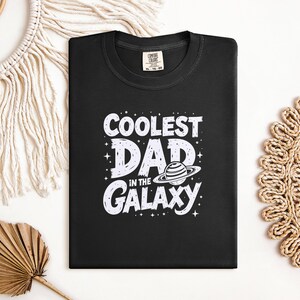 Coolest Dad in the Galaxy T-Shirt, Fun Graphic Tee for Fathers, Perfect Gift for Dads, Galaxy Print Dad Shirt, Space Theme Dad Shirt