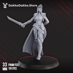 May include: A grey figurine of a female character in a military uniform, holding a sword. The figure is 3.3 cm tall from feet to eyes. The figure has a hat, cape, and detailed armour. The DakkaDakka.Store logo is in the top left corner.