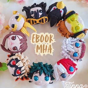 May include: A collection of crocheted character heads from the anime series, My Hero Academia, arranged in a circle. Each head features distinct hair and facial details, with the text "EBOOK MHA" and the artist's signature visible.
