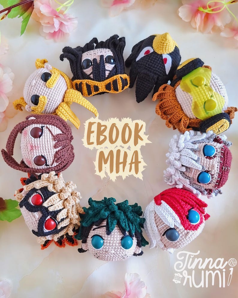 May include: A collection of crocheted character heads from the anime series, My Hero Academia, arranged in a circle. Each head features distinct hair and facial details, with the text "EBOOK MHA" and the artist's signature visible.