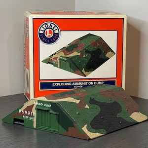 May include: A white ceramic mug with a black handle and the text "But First, Coffee" in a black, handwritten-style font. The mug is on a white surface.