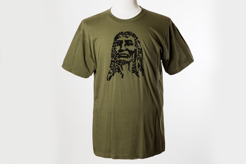 May include: A green t-shirt with a black graphic of a person's face made up of words. The words include "We are the future".