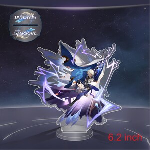 May include: A clear acrylic stand with a 6.2 inch tall figure of a character from the video game Honkai: Star Rail. The character is a young man with white hair and blue eyes, wearing a blue and white outfit. He is holding a sword and surrounded by purple and blue energy effects.