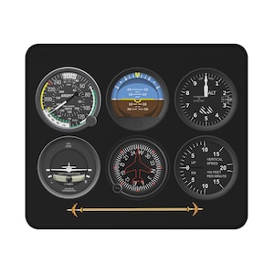 May include: Black rectangular mousepad featuring six aviation instrument gauges. The gauges display airspeed, attitude, altitude, flight coordination, compass, and vertical speed. A gold-colored line with airplane icons is at the bottom.