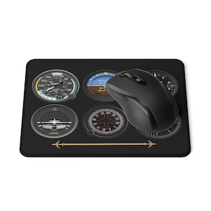 May include: Black mouse mat with aviation instrument panel gauges. A black wireless mouse sits on the mat. The gauges include an airspeed indicator, altimeter, and compass. A gold airplane graphic is at the bottom.