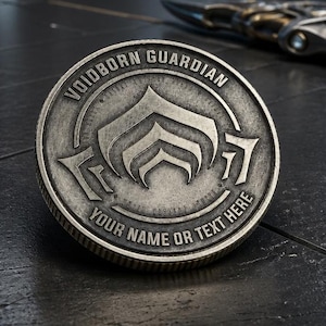 May include: A silver-colored coin with the text "VOIDBORN GUARDIAN" and "YOUR NAME OR TEXT HERE" around the edge. The coin features a stylized emblem in the center. A futuristic-looking sword is partially visible in the background.