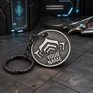 Llavero personalizado de Warframe de latón macizo de 30 mm con relieve y anilla (doble cara).