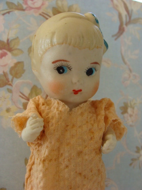 NAKA JAPANESE BABY GIRL BISQUE DOLL SITTING ON PILLOW