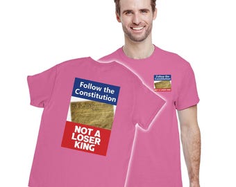 May include: Pink t-shirt with the text "Follow the Constitution" and "Not a Loser King" printed on the back. The design includes an image of the U.S. Constitution. A smaller version of the design is on the front.