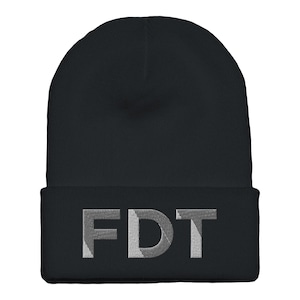 May include: Black beanie hat with the embroidered letters "FDT" in a light gray color. The hat is a classic style, with a folded cuff and a rounded top. The letters are blocky and easy to read.