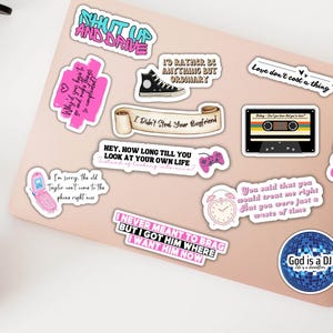 May include: A set of pink and black stickers featuring quotes and designs from the popular TV show "The Summer I Turned Pretty". The stickers include quotes such as "Shut Up and Drive", "I'd Rather Be Anything But Ordinary", "Love Don't Cost a Thing", "Hey, How Long Till You Look At Your Own Life", "I Never Meant to Brag But I Got Him Where I Want Him Now", "You Said That You Would Treat Me Right But You Were Just a Waste of Time", "God is a DJ", and "I Didn't Steal Your Boyfriend".