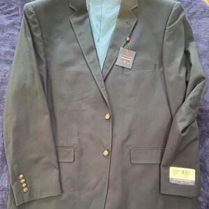 May include: A dark blue blazer with gold buttons and a plaid lining. The blazer has a brand tag that says "SADDLEBROOK" on it.