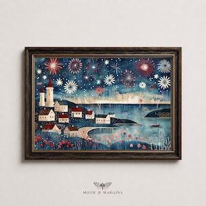 May include: A framed horizontal art print depicting a coastal village at night under a dark blue sky filled with red and white fireworks. The scene features small houses, a lighthouse, a sailboat on the water, and red flowers in the foreground.