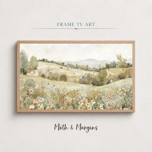 May include: A framed landscape print depicting a tranquil meadow with a small white cottage, rolling hills, and wildflowers. The artwork is in a wooden frame and includes the text "FRAME TV ART" and "Moth & Margins".