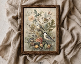 May include: A framed print featuring a botanical illustration of four small birds perched among oak leaves, acorns, and a pale pink flower. The artwork is rendered in muted earth tones and includes the text MOTH & MARGINS at the bottom.