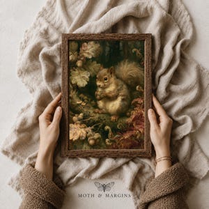 May include: A rectangular dark brown wooden frame containing a detailed painting of a squirrel holding a nut, surrounded by oak leaves and forest foliage. The artwork features earthy tones of brown, green, and gold, capturing a woodland scene.