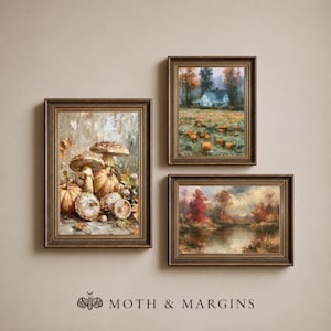 May include: Three framed wall art prints in dark wood frames. One vertical print depicts mushrooms and pumpkins. A second vertical print shows a house in a pumpkin patch. A third horizontal print features a landscape with a pond and autumn trees.
