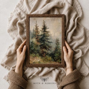May include: A rectangular framed wall art piece featuring an oil painting of a dense forest with tall evergreen trees in shades of deep green and muted brown. The frame has a dark brown textured wood grain finish, surrounding the landscape scene.