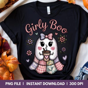 May include: Black t-shirt with the text "Girly Boo" in pink script. The shirt features a cute ghost illustration holding a coffee cup, surrounded by flowers and hearts. The ghost has a patchwork quilt design.