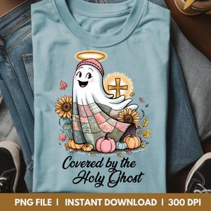 A powder blue t-shirt showcasing a charming holy ghost design with soft autumn elements and a Christian message. The pastel background adds a gentle, calming touch — perfect for faith-filled fall fashion with a cozy vibe.