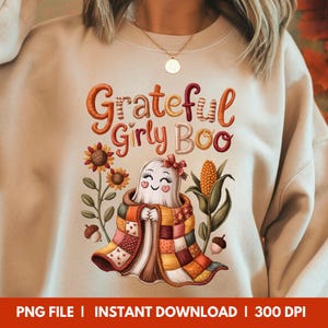 May include: Beige sweatshirt with the text "Grateful Girly Boo" in orange and red. A smiling ghost wearing a patchwork quilt is in the center, surrounded by sunflowers, corn, and acorns. The bottom of the image reads "PNG FILE | INSTANT DOWNLOAD | 300 DPI".