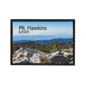 May include: A rectangular patch featuring a scenic view of Mt. Hawkins. The patch displays the text "Mt. Hawkins 8,850ft" at the top and a sign that reads "MT HAWKINS 8850" at the bottom. The image shows a mountain range under a blue sky.