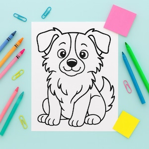 May include: A black and white line drawing of a dog sitting on a white sheet of paper. The drawing is surrounded by colorful crayons, paper clips, and sticky notes on a light blue surface. The dog has a fluffy coat and a friendly expression.