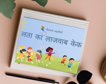 May include: A children's book with a light blue cover featuring illustrations of children playing. The title is in a foreign language. A black pen and sunglasses are next to the book on a pink surface.