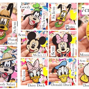 May include: A collection of embroidered fabric patches featuring various cartoon characters including Mickey, Minnie, Donald, Daisy, Goofy, and Pluto in safari, sailor, and classic outfits, with printed dimensions ranging from 6x8cm to 8x7cm.