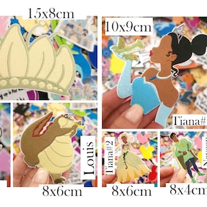 May include: A collection of colorful fabric patches featuring characters and symbols. Includes a gold crown (15x8cm), a princess, a pirate hat, playing cards, a firefly, a cartoon alligator, and other characters.