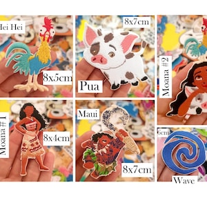 May include: A collection of Moana-themed embroidered patches featuring characters like Hei Hei, Pua, Maui, and Moana, along with symbols like a wave, stingray, stone, and hook. Each patch includes text labels and dimensions in cm, such as 10cm, 8x7cm, and 5x4cm.